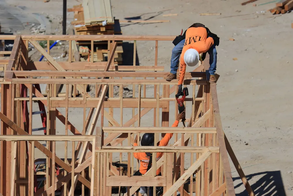 Crew setting a wall on a second story